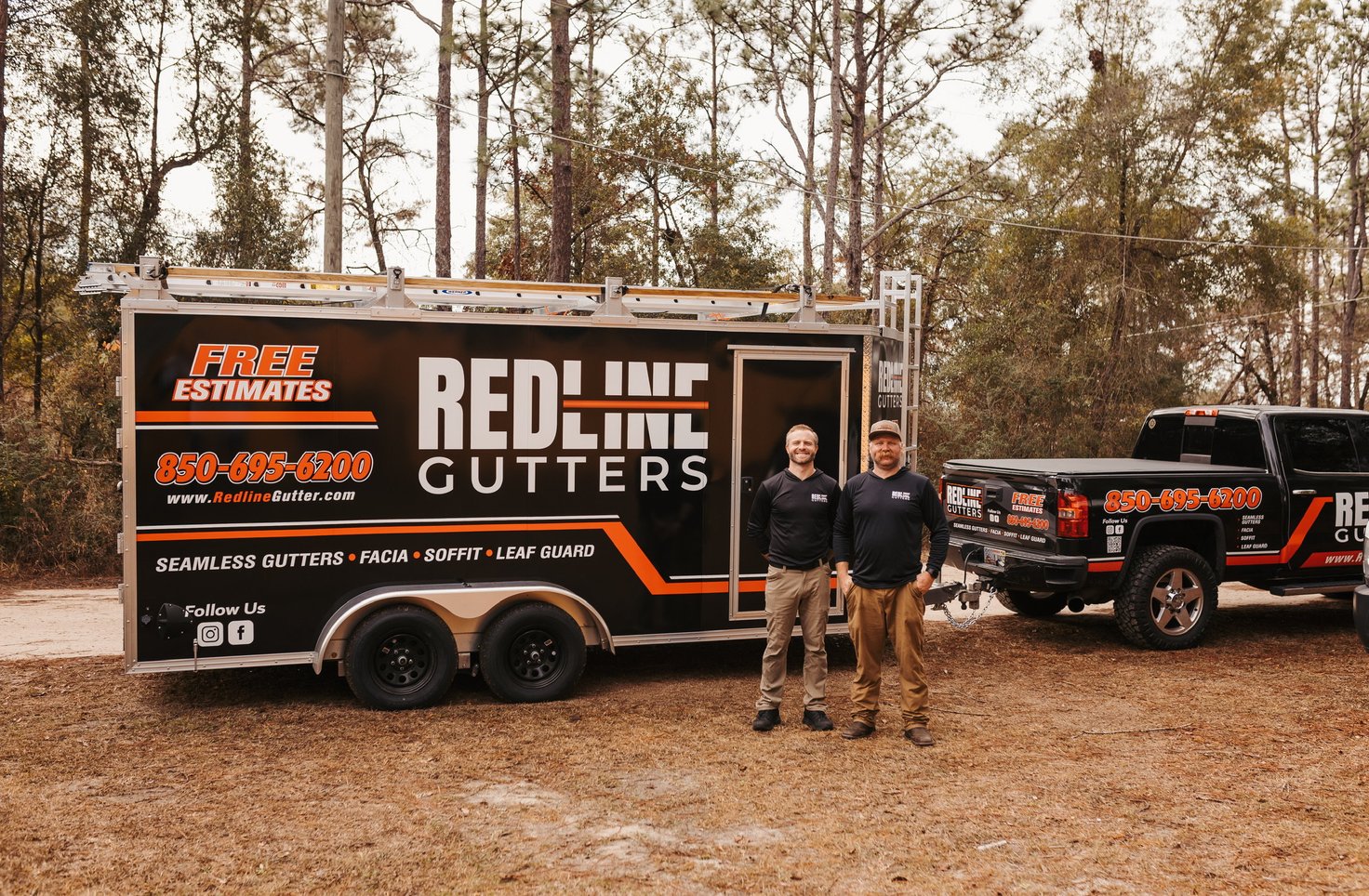 Red Line Gutters owners standing next to their branded truck and trailer